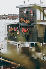A house boat with hanging flowers