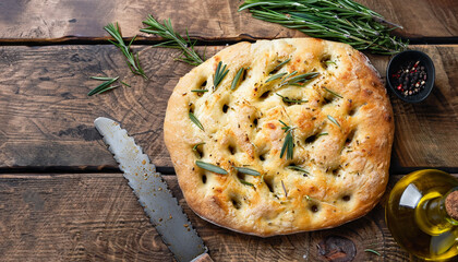 Italian traditional focaccia bread baking with aromatic seasonings and rosemary on old wooden...