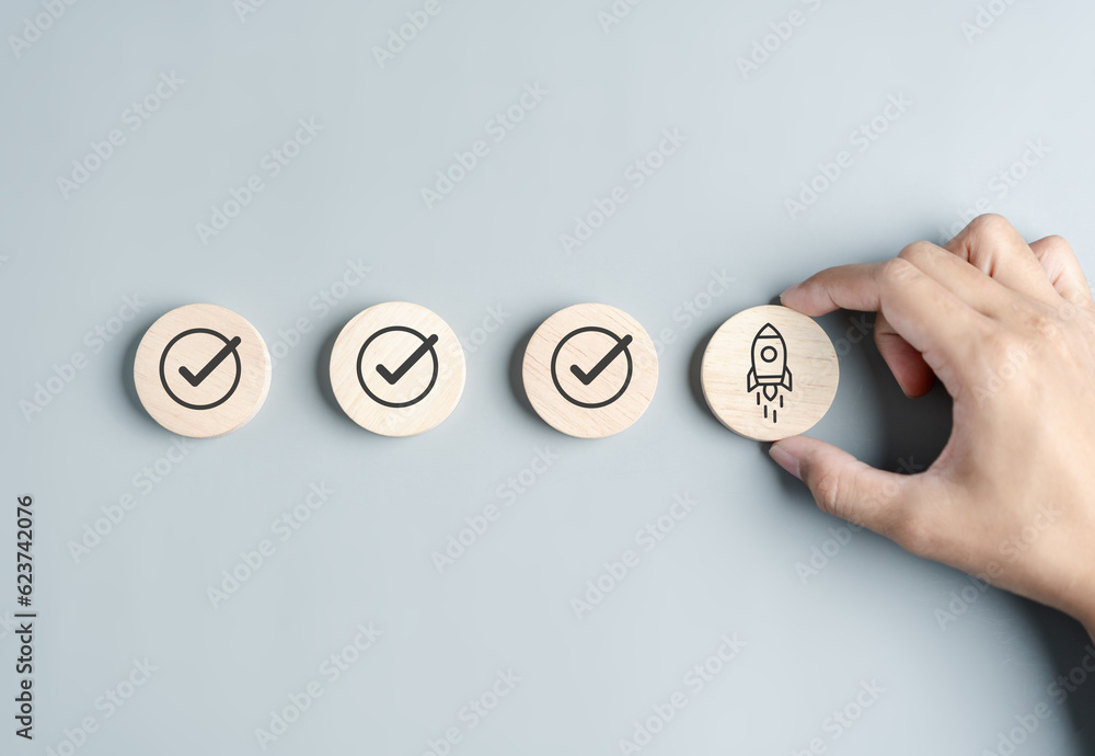 Fototapete hand business with rocket launch icon, fast start up business checklist step to goal and success obj