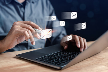 Businessman sending email by laptop computer to customer, business contact and communication, email icon, email marketing concept, send e-mail or newsletter, online working internet network