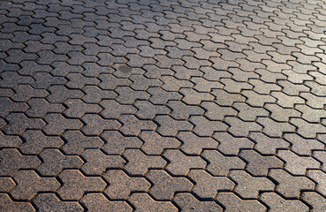 Paver brick floor, brick paving, paving stone or block paving. Manufactured from concrete or stone for road, path, driveway and patio. Empty floor in perspective view selective focus