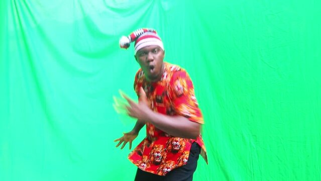 Mature male hop on one foot in demonstration of the cultural Igbo greeting in Public