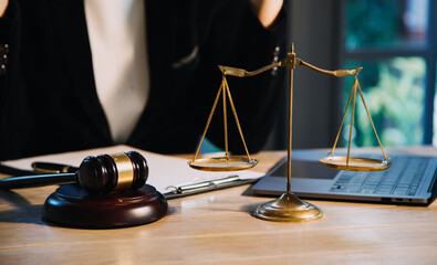 Justice and law concept.Male judge in a courtroom with the gavel, working with, computer and...