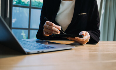 close up hands multitasking man using tablet, laptop and cellphone connecting wifi