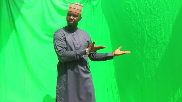 African man present product in Hausa cultural cap and sad expression on his face as bad productt