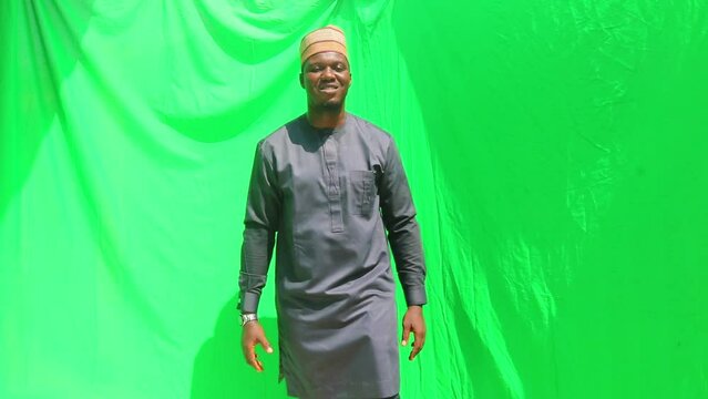 Matured business man in African walks and extends a handshake to the view at three different proximity with the camera with green screen