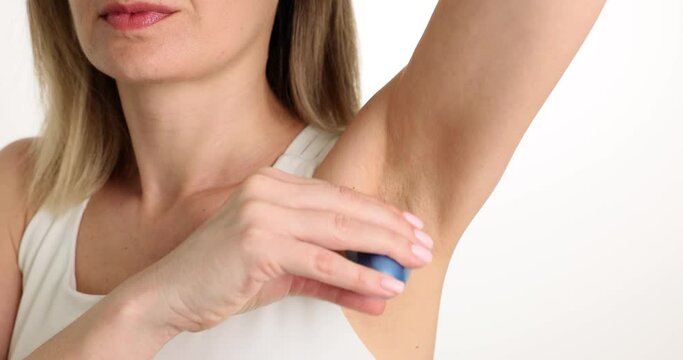 Personal hygiene and a young woman applies deodorant to armpit. Deodorant antiperspirant for woman