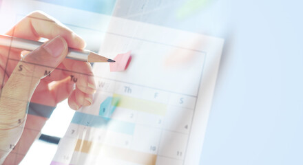 2024 event planning, Business plan and to do list concept. Woman hand with a pencil writing on calendar planner schedule with copy space, mock up, vintage style