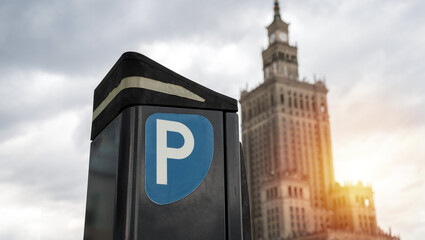 Parking meter, Parkometr or Parkomat in paid parking zone of Warsaw, Poland city centre downtown district. Car park pay and display ticket machine. Palace of Culture and Science in background. - obrazy, fototapety, plakaty