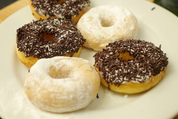 Variety of donuts with almond, chocolate, colorful chocolate rice