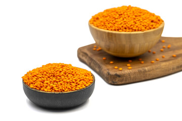 Red lentils isolated on white background. Raw red lentils in bowl