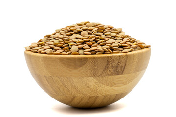 Green lentils isolated on white background. Raw green lentils in wooden bowl