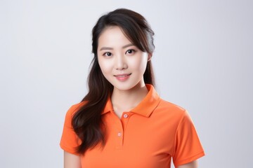 Fototapeta premium Portrait of a beautiful asian woman in orange t-shirt