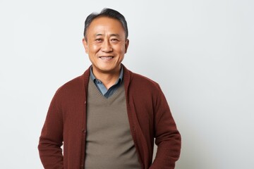 Portrait of a happy asian senior man standing on white background