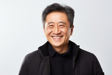 Obraz premium Portrait of a happy mature Asian man smiling isolated over white background