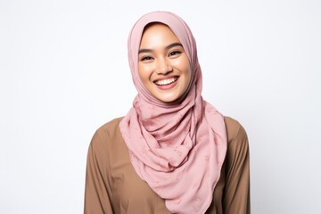 Portrait of Asian muslim woman in hijab smiling at camera.