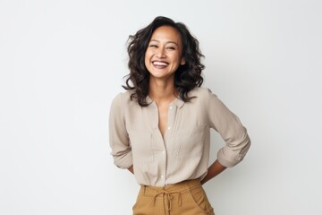 Portrait of a smiling businesswoman standing with hands on hip over white background