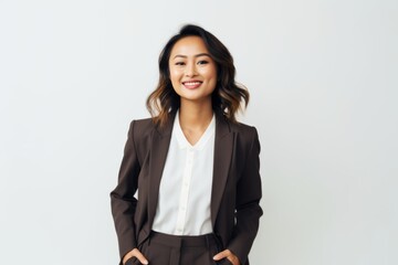 Portrait of a smiling asian businesswoman standing against white background