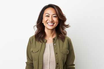 Portrait photography of a pleased Indonesian woman in her 40s wearing a chic cardigan against a white background 