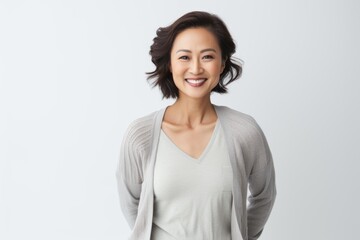 Portrait of happy asian woman in casual clothes standing over white background.
