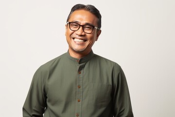 Portrait of a smiling Indian man in green shirt and eyeglasses