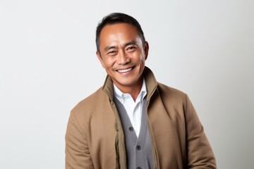 Portrait of happy asian man smiling at camera on white background