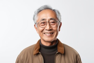 Portrait of a happy asian senior man smiling at camera isolated over white background