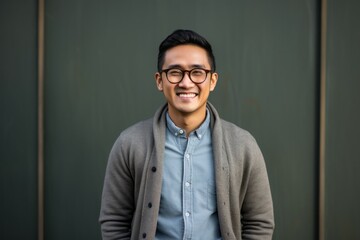 Obraz premium Portrait photography of a pleased Indonesian man in his 30s wearing a chic cardigan against an abstract background 