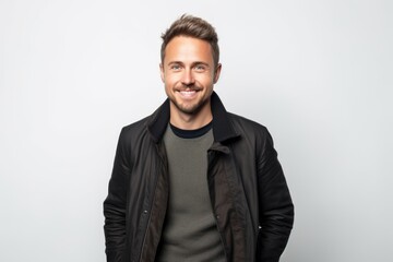 Obraz premium Portrait of a handsome young man in a leather jacket on a white background