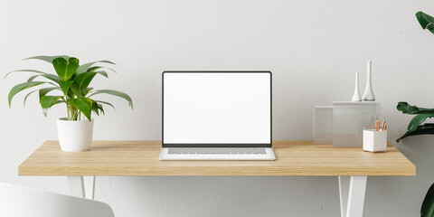 Laptop in a minimalist and modern desk with plants