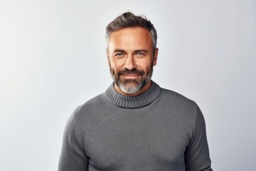 Handsome middle-aged man in a gray sweater on a white background