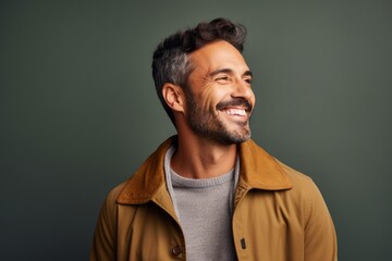 Fototapeta premium cheerful indian man smiling and looking away isolated on grey