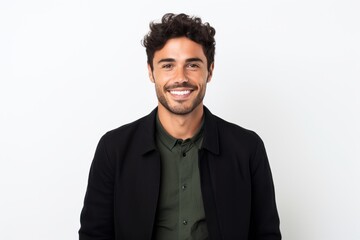 Portrait of a handsome young man smiling at the camera while standing against white background