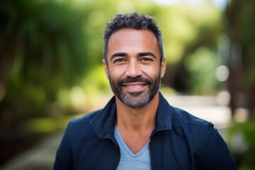 Fototapeta premium Portrait photography of a satisfied Brazilian man in his 40s wearing a chic cardigan against an abstract background 