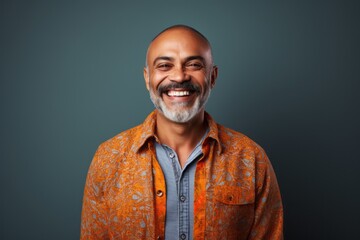 Fototapeta premium Portrait of a happy mature Indian man smiling at the camera.