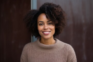 Fototapeta premium Portrait of smiling african american woman standing by door at home
