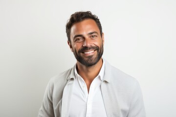 Fototapeta premium Portrait of a handsome man smiling at the camera against white background