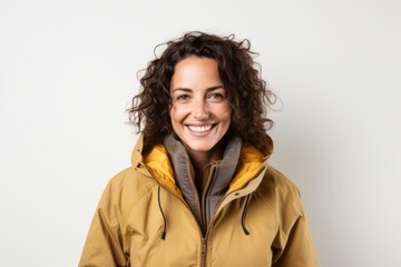 Portrait of a smiling woman in a yellow jacket on a white background