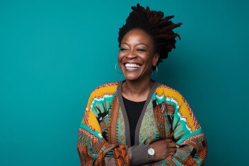 Portrait of a smiling african american woman with afro hairstyle on blue background
