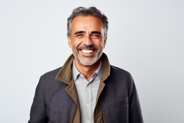 Portrait photography of a pleased Brazilian man in his 50s wearing a chic cardigan against a white background 