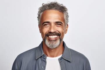 Portrait of smiling middle-aged man looking at camera over white background