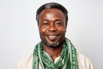Obraz premium Portrait of a smiling african american man with a green scarf