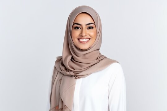 Portrait of beautiful young muslim woman with hijab smiling at camera