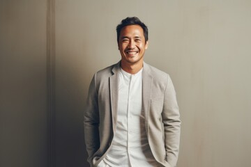 Obraz premium Portrait of a handsome asian man smiling and looking at camera