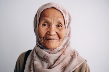 Portrait of an old muslim woman with hijab looking at camera