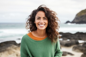 Portrait of a smiling woman standing on the beach at the beach