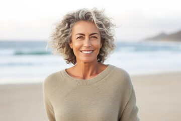 Portrait of smiling middle aged woman at beach on a sunny day