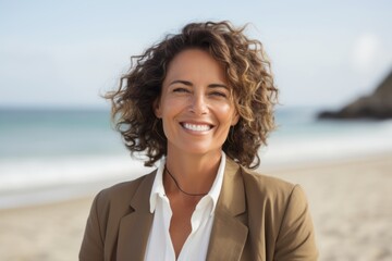 Portrait of smiling businesswoman standing on the beach at the day time
