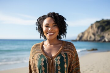 Portrait of smiling young woman standing at beach on a sunny day