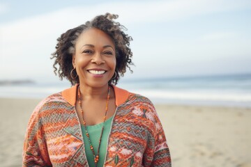 Portrait of a smiling young african american woman on the beach